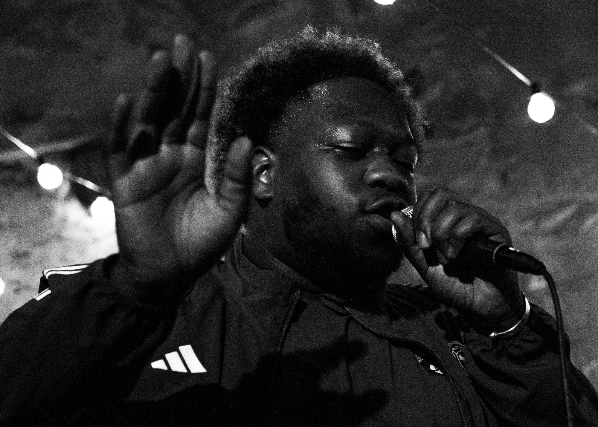 Un rappeur au micro, la main levée